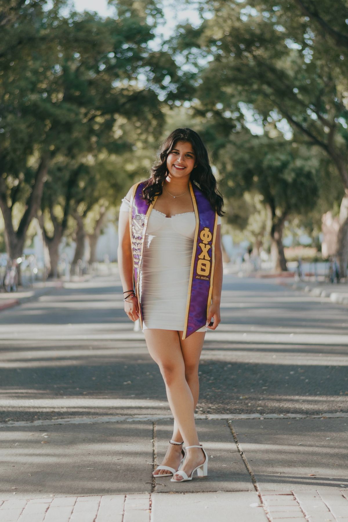 Rishita Dwivedi wearing a Phi Chi Theta graduation stole